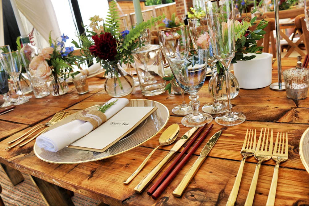 a wooden table topped with plates of food
