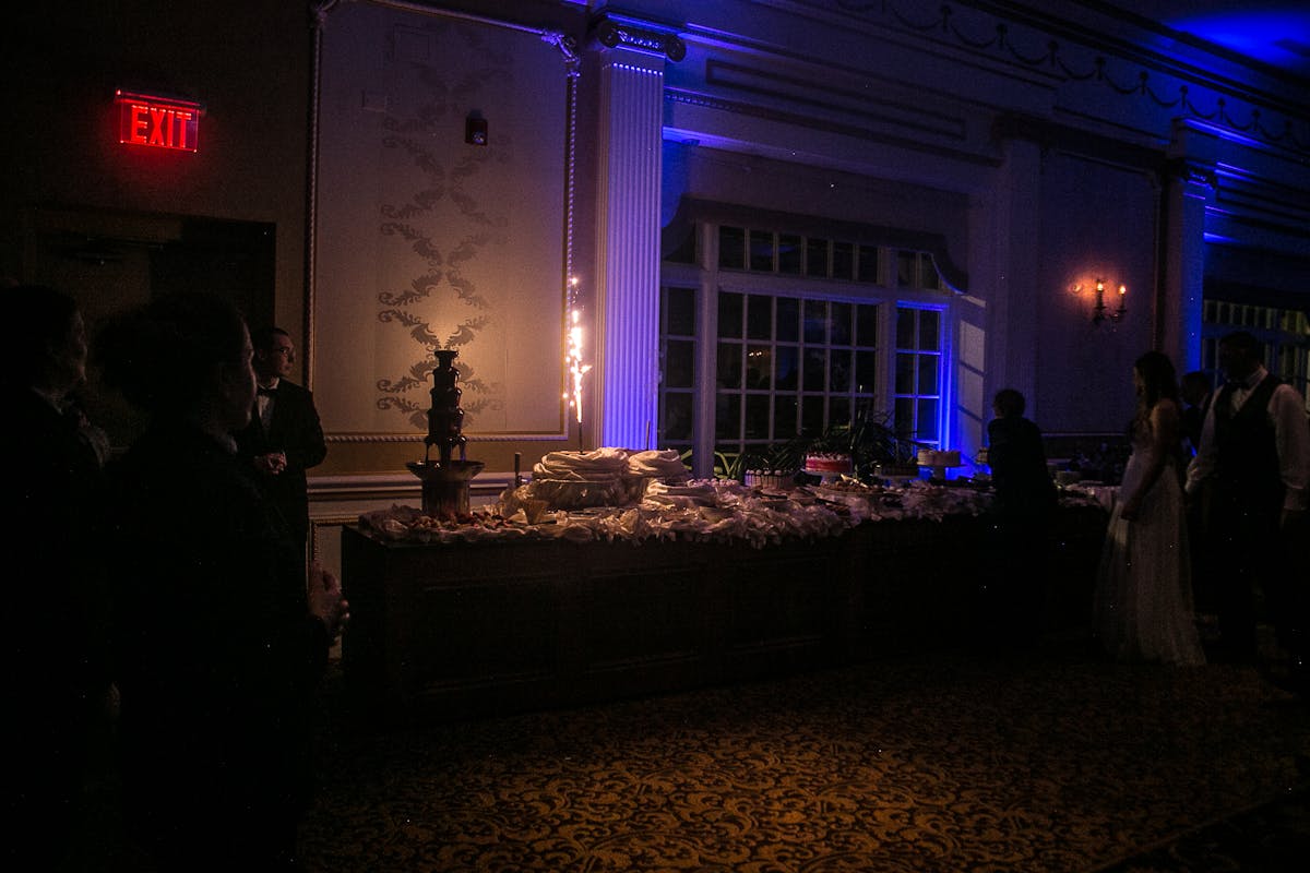 a couple of people that are standing in a dark room