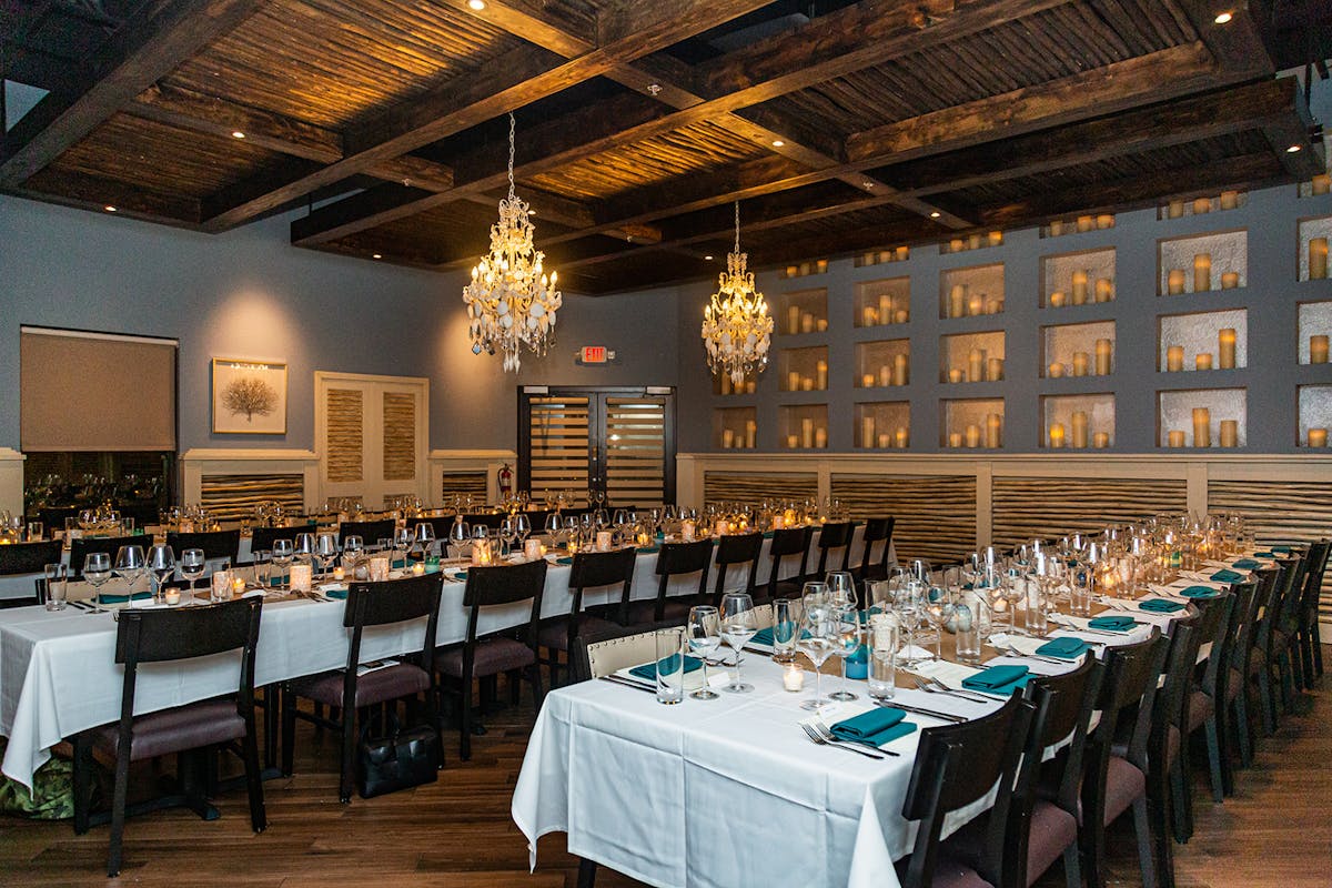 a group of people sitting around a long table