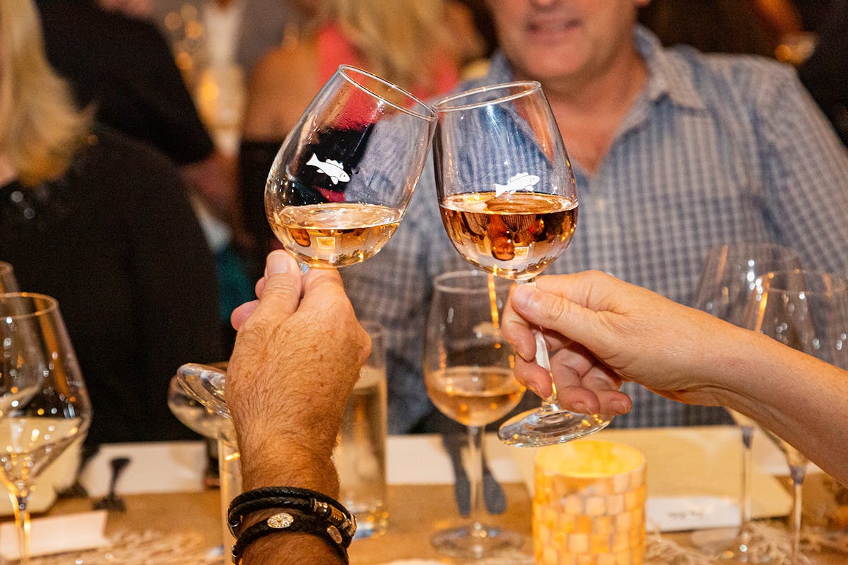 a person holding a glass of wine