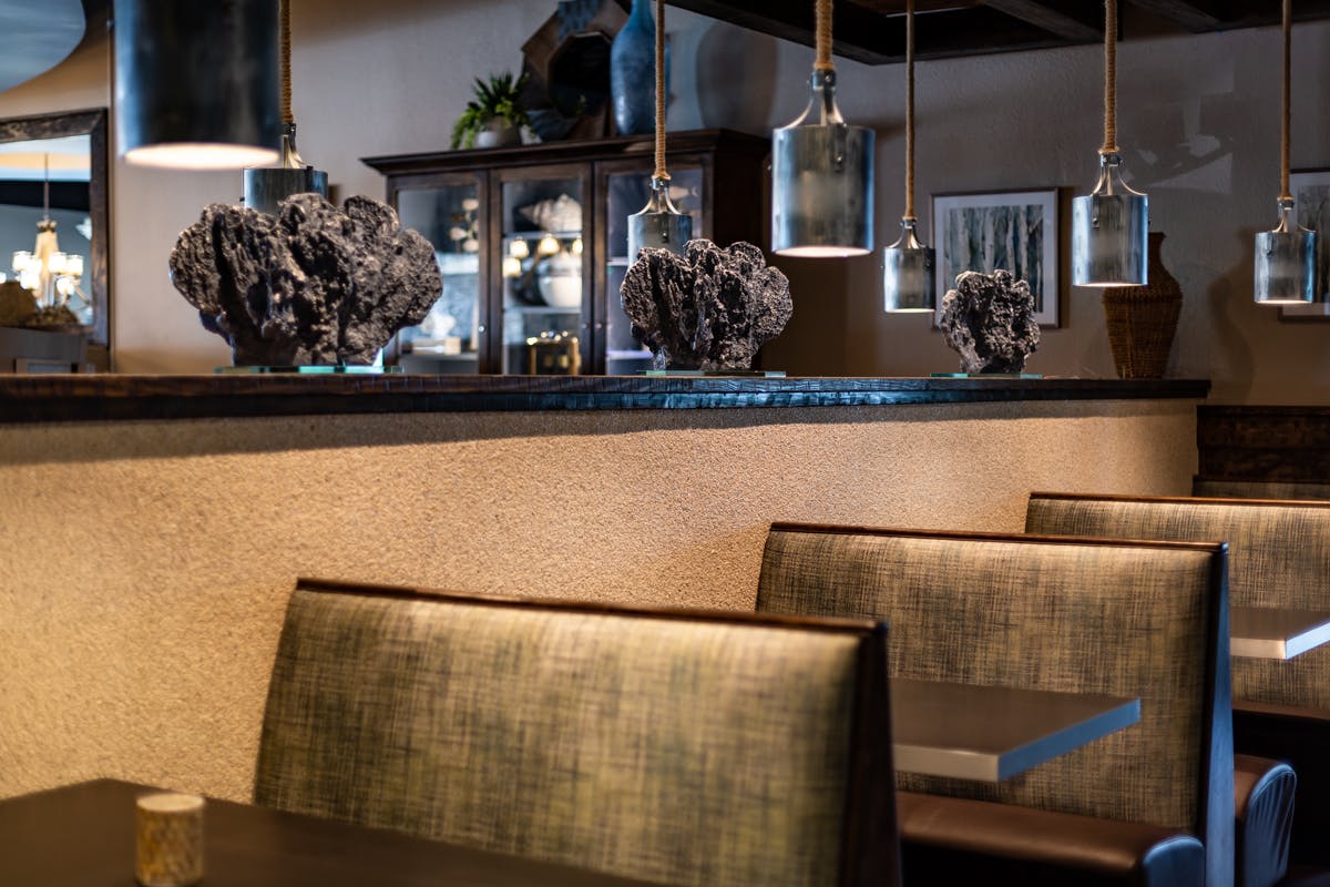 a dining room filled with furniture and vase on a table