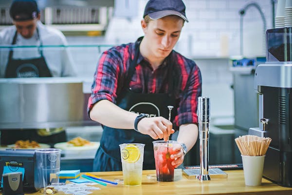 a restaurant worker making a drink