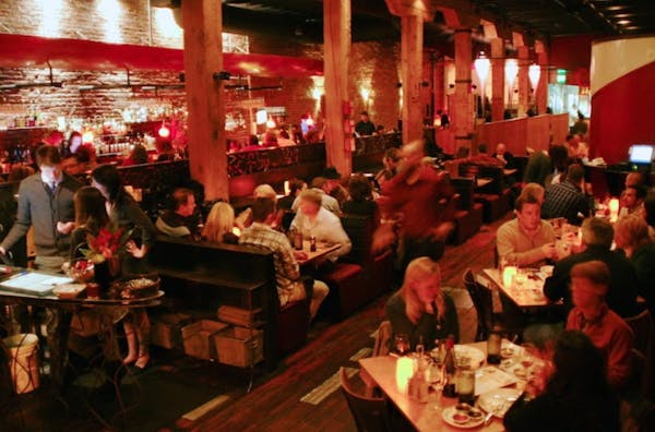 a group of people sitting at a table in a restaurant