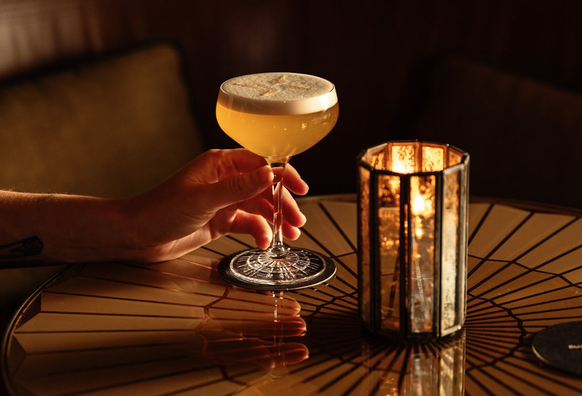 a close up of a wine glass sitting on a table