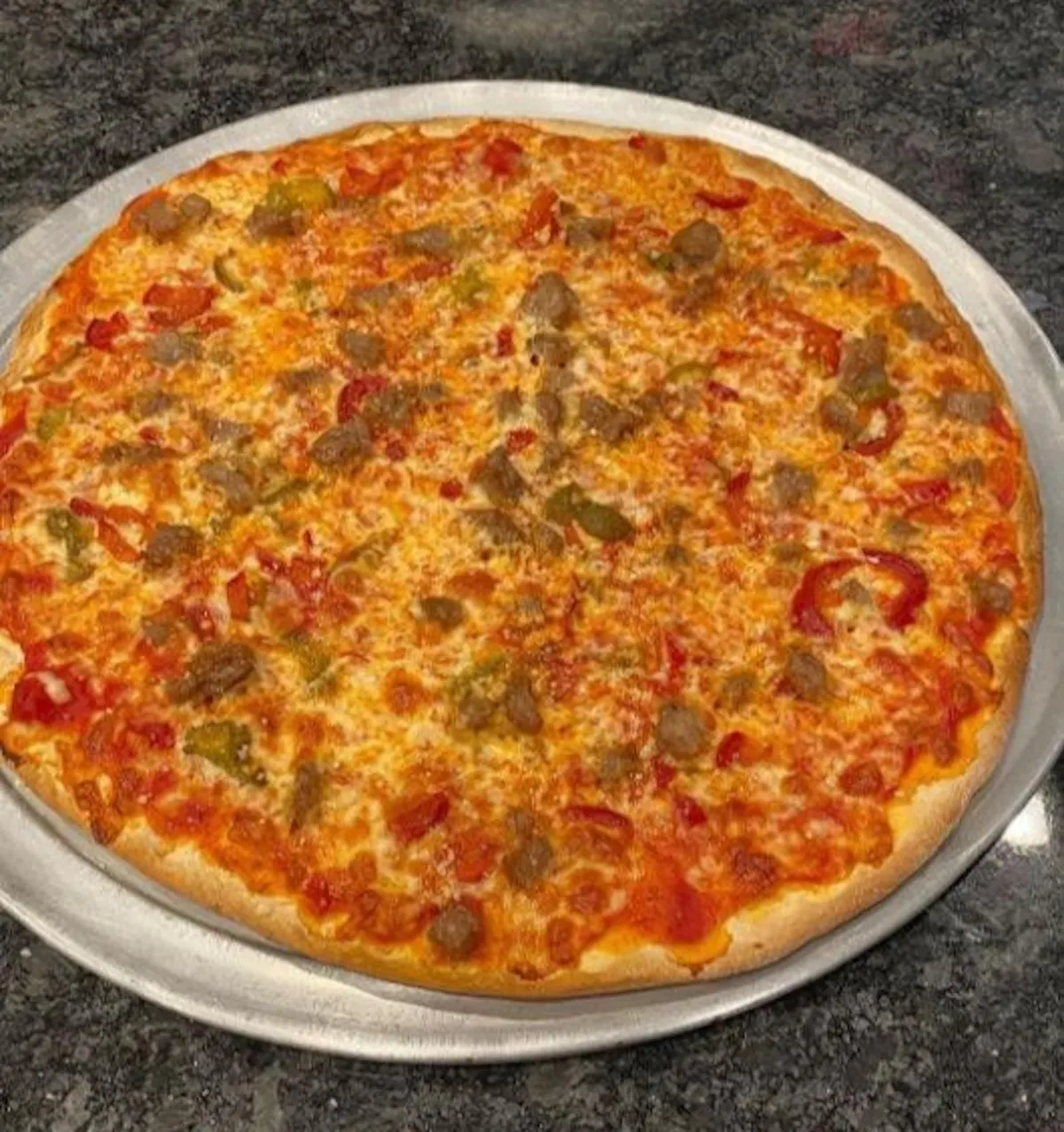 a pizza sitting on top of a pan on a table