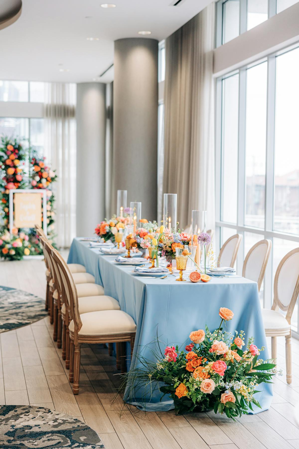 a room filled with furniture and vase of flowers on a table