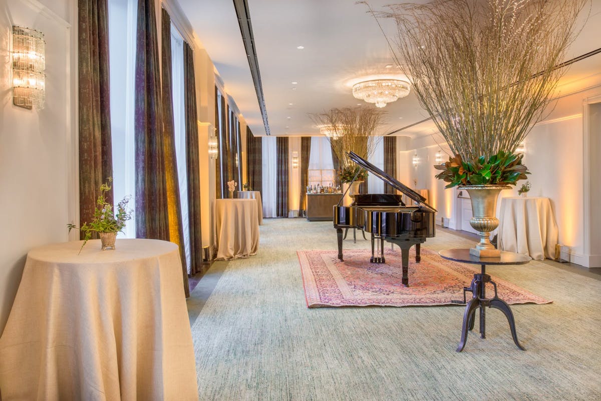 a room filled with furniture and vase of flowers on a table