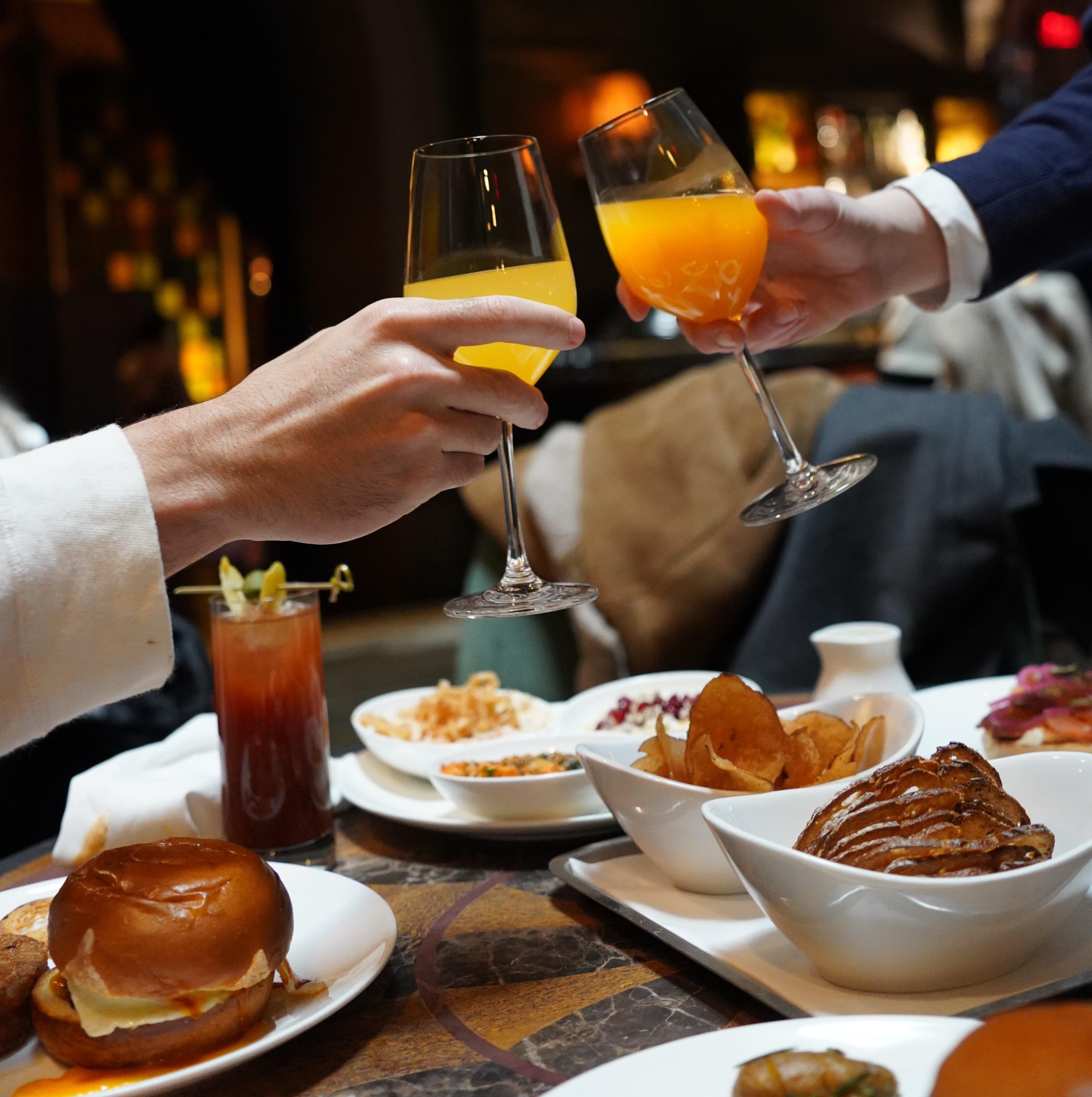 a group of people toasting with drinks