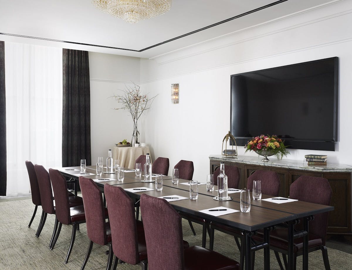 a room filled with furniture and vase of flowers on a table