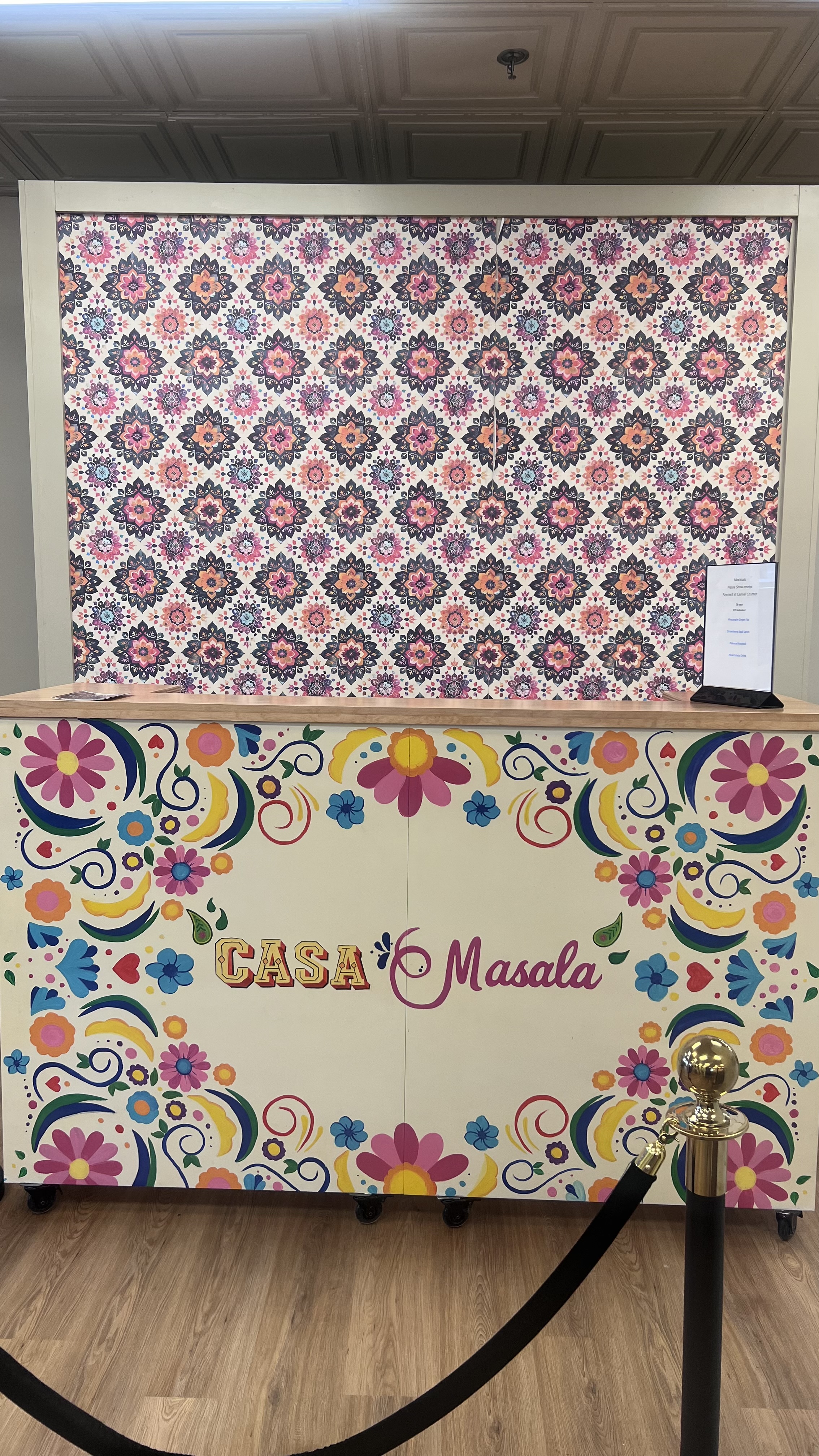 south Asian and mexican inspired hand painted artwork on a custom made bar provides fun vibes for any party atmosphere and a cool colorful wallpaper that can be used as backdrop to bar