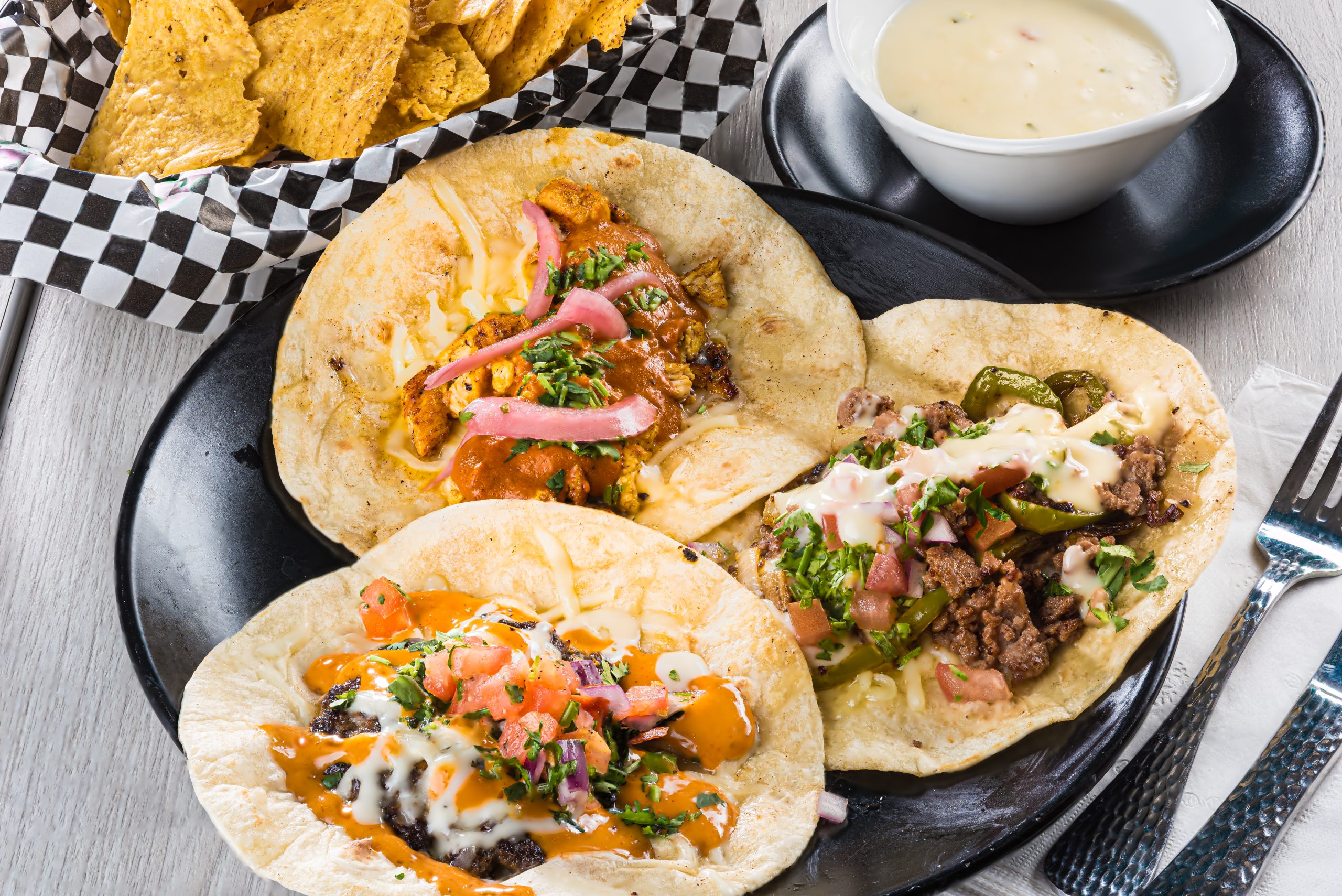butter chicken taco, cheeseburger taco and a ribeye steak taco