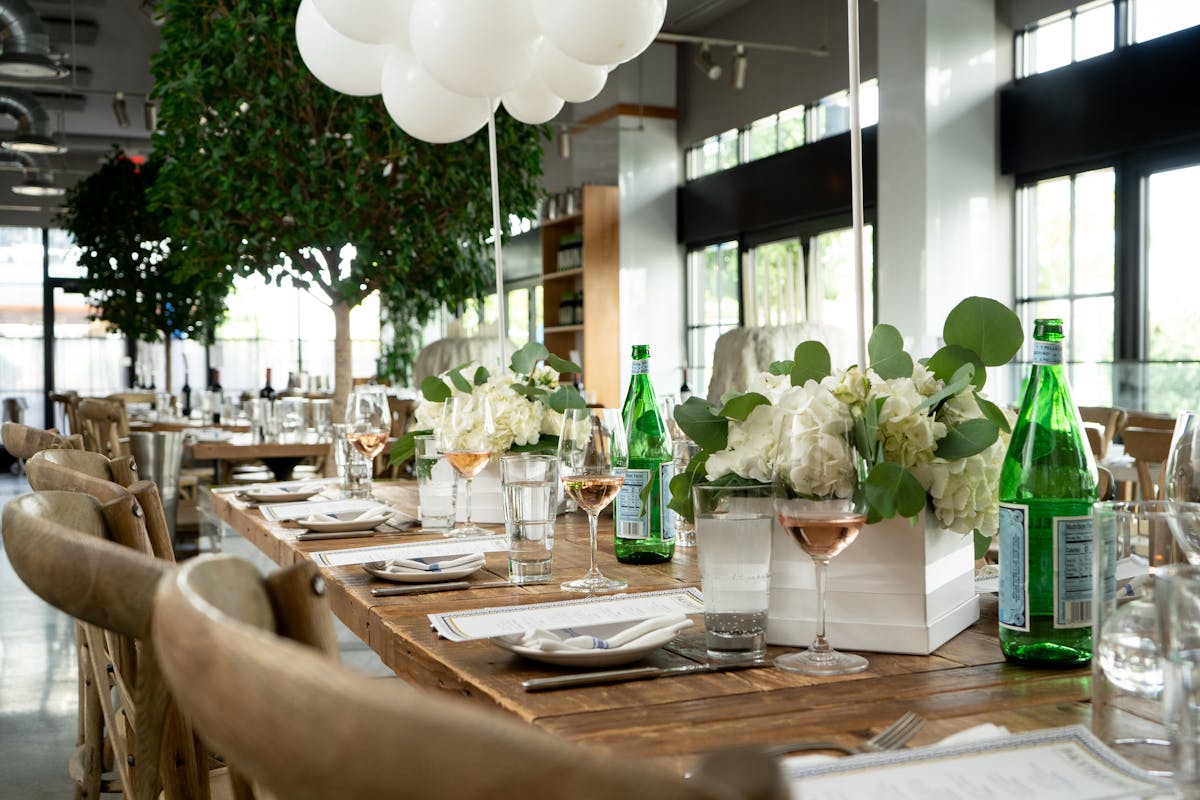 a group of people sitting at a table with wine glasses