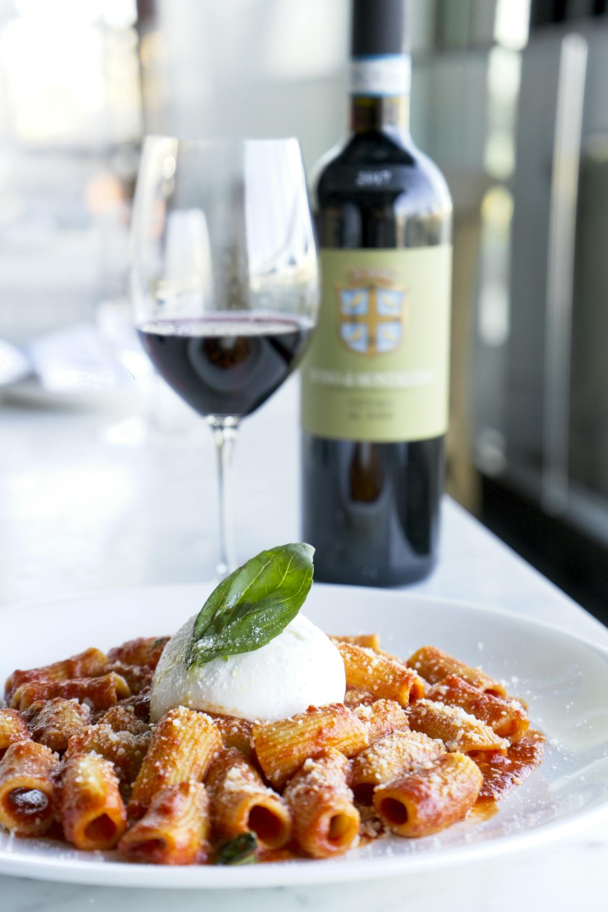 a close up of a plate of food and a bottle of wine