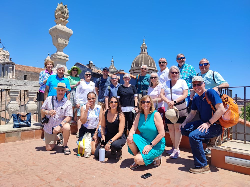 a group of people standing in front of a crowd posing for the camera