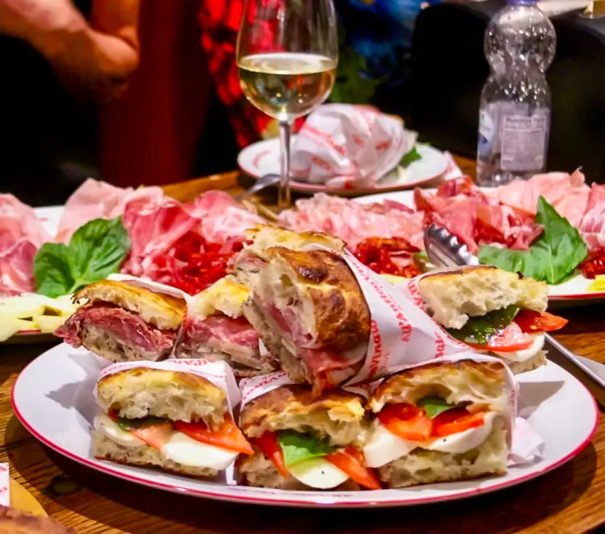 a group of people sitting at a table with a plate of food