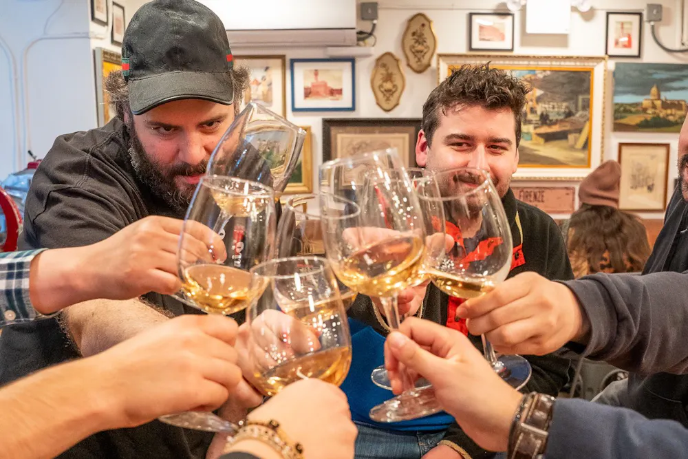 a group of people sitting at a table with wine glasses