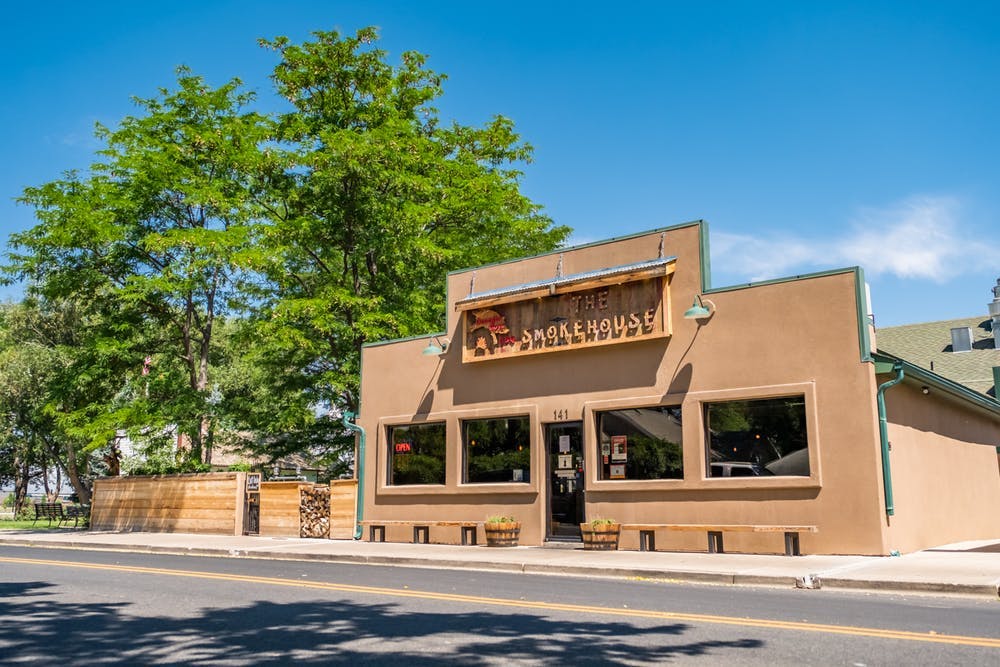a building that has a sign on the side of a road
