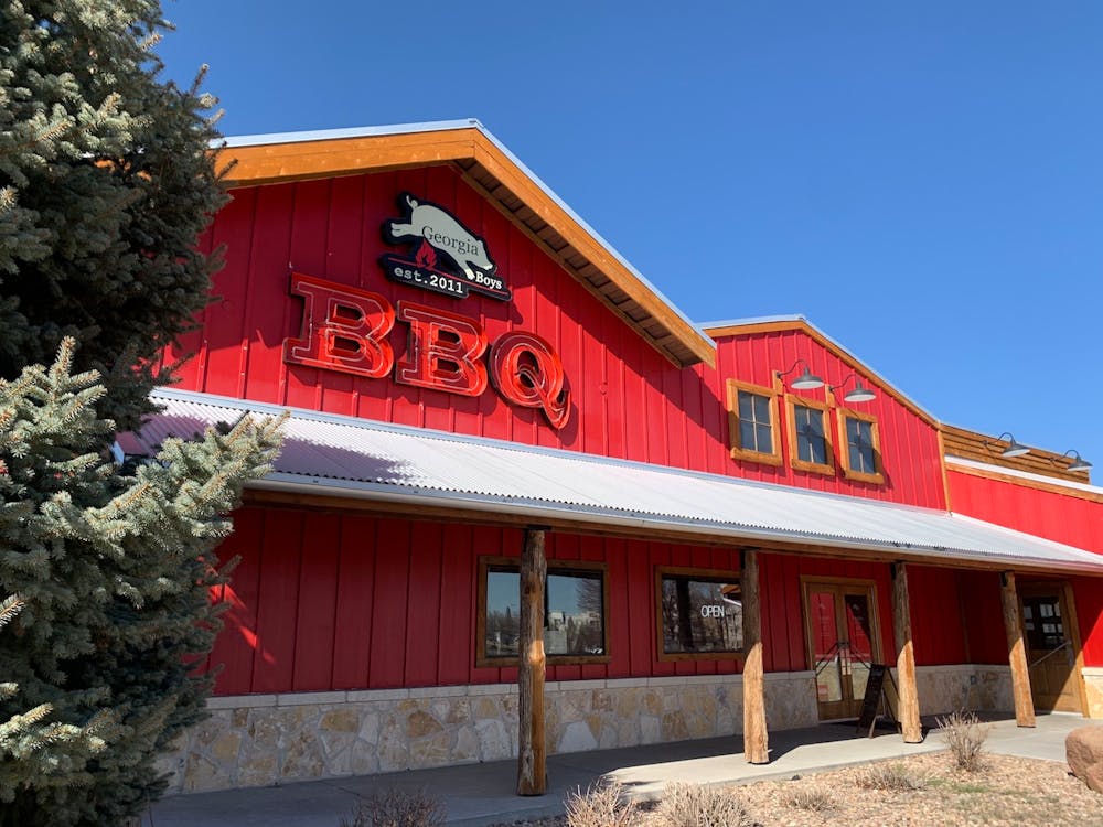 a house that has a sign on the side of a building