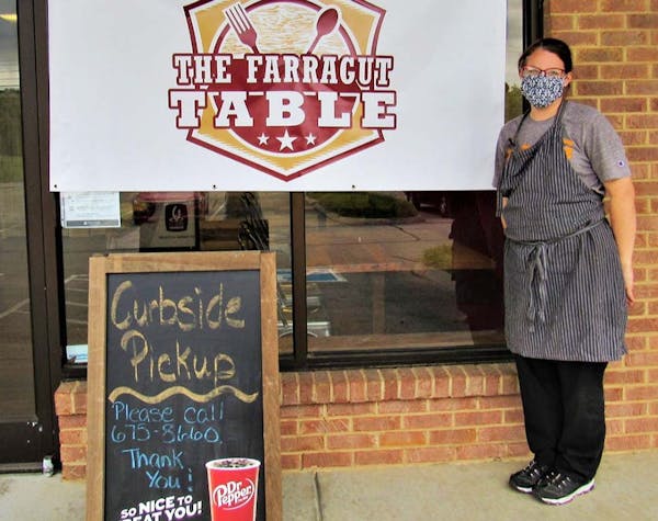 a man standing in front of a sign