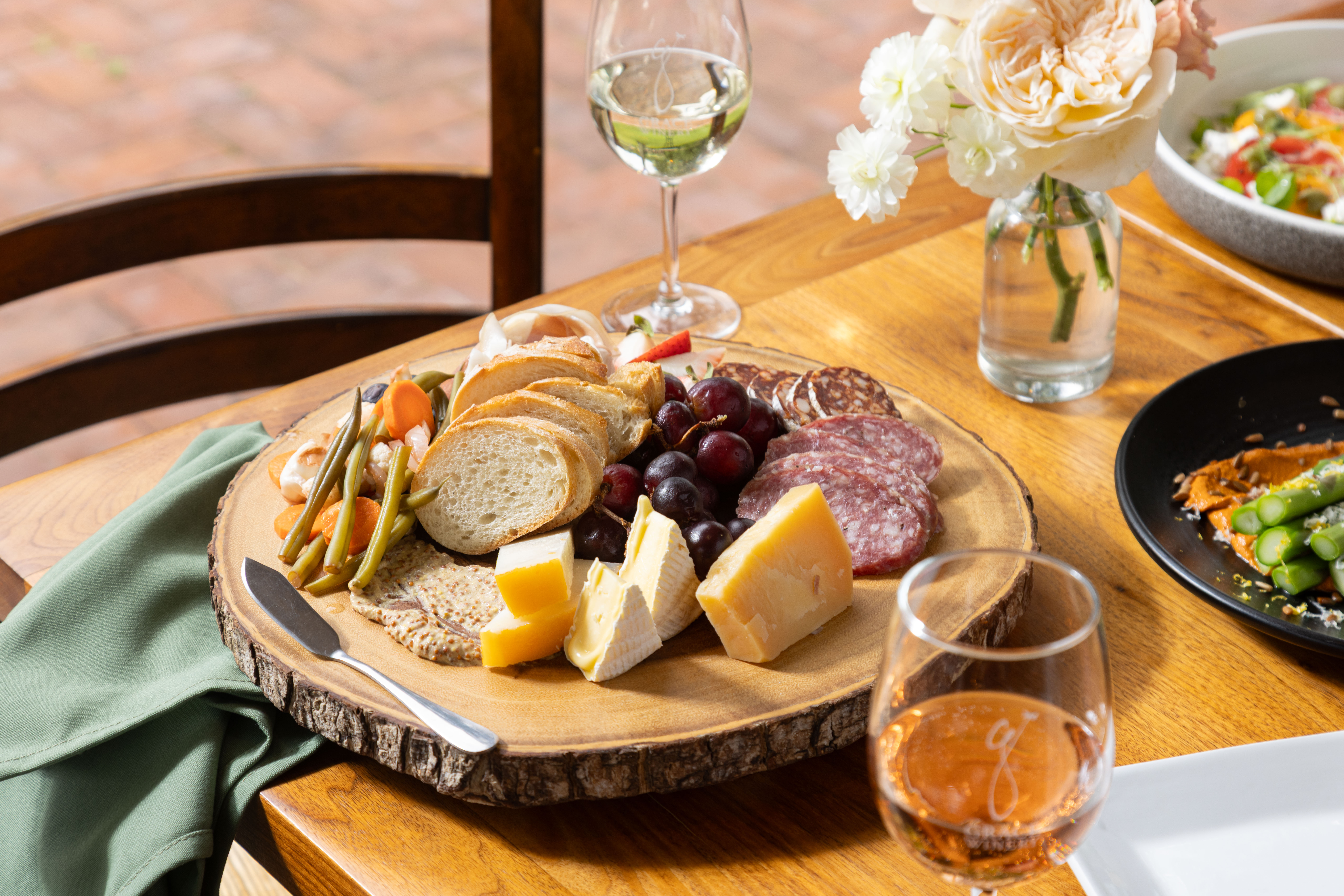 a plate of food and glasses of wine on a table