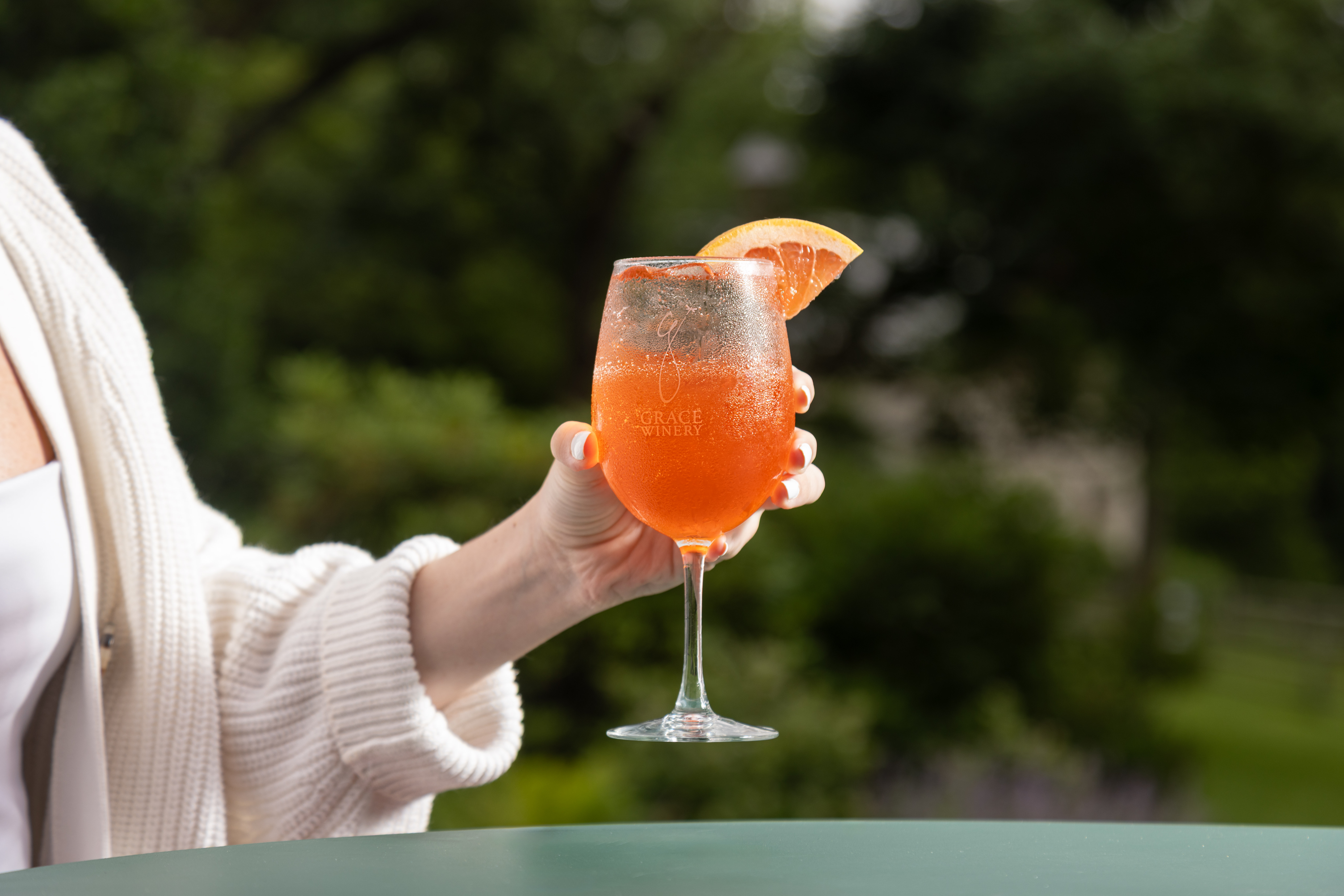 a hand holding a glass of wine