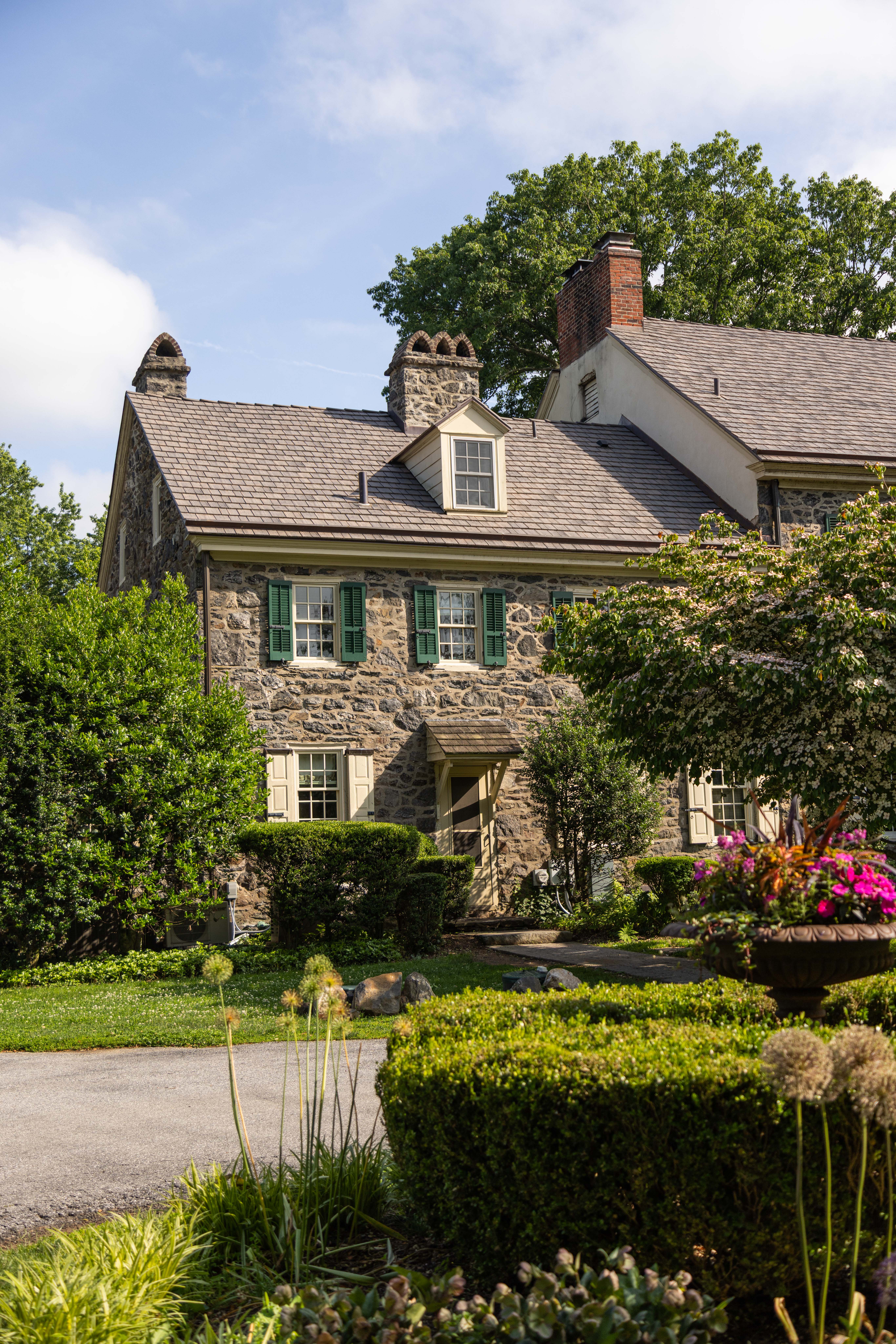 a house with bushes in front of a building
