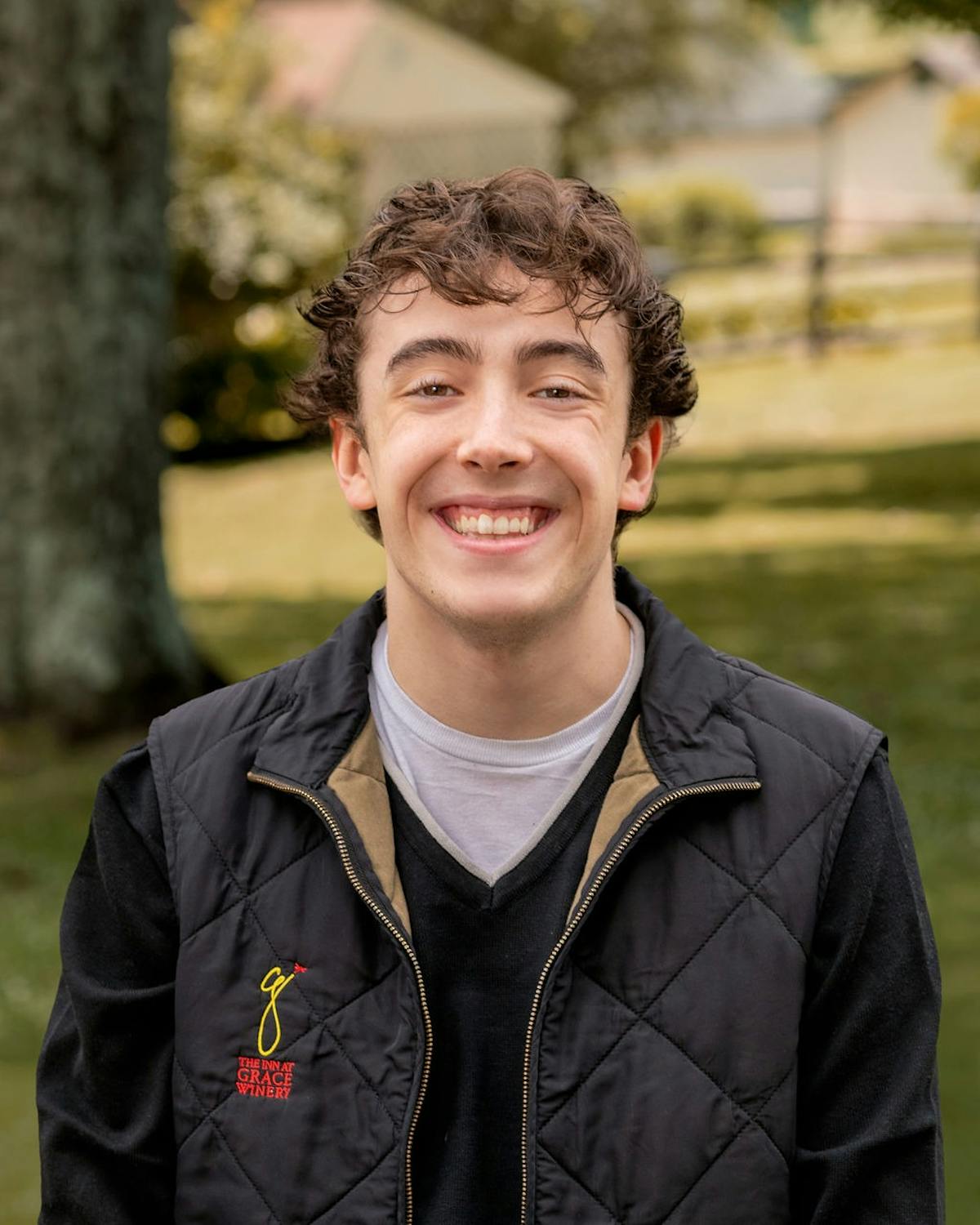 a man wearing a jacket and smiling at the camera