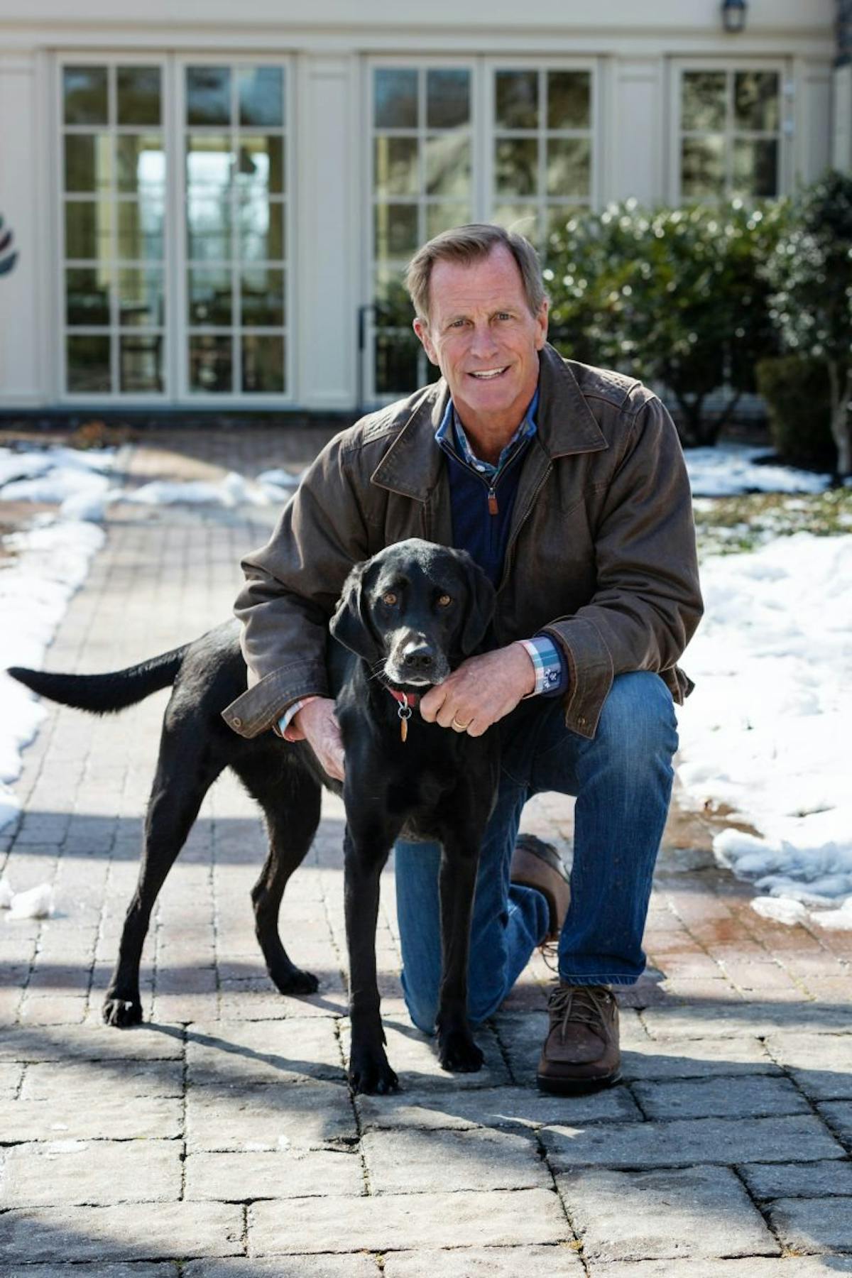 a man and a dog posing for the camera
