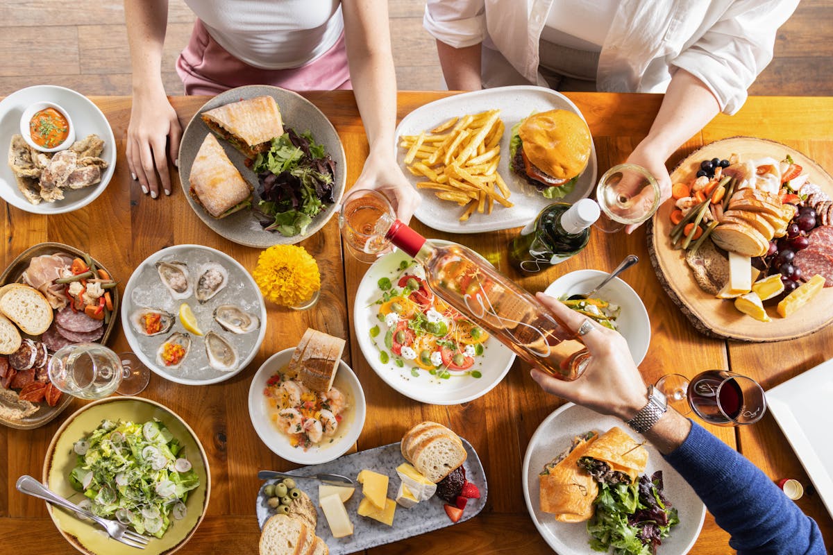 a group of people sitting at a table with a plate of food