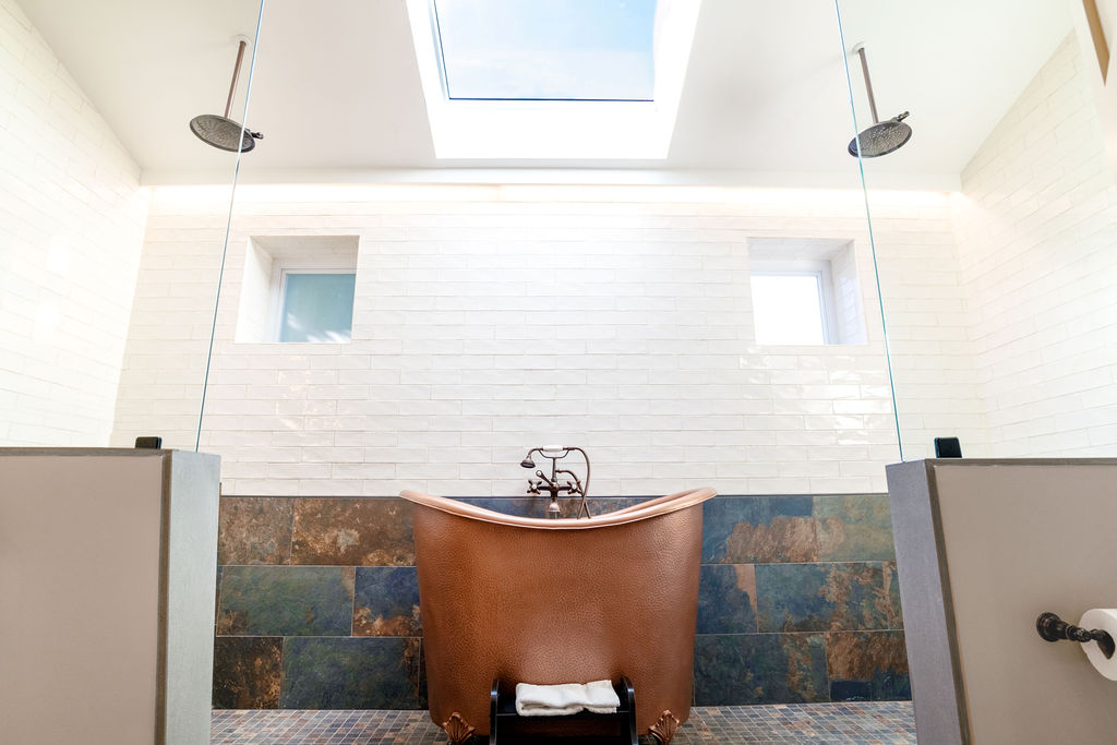 a bathroom with a copper tub and shower