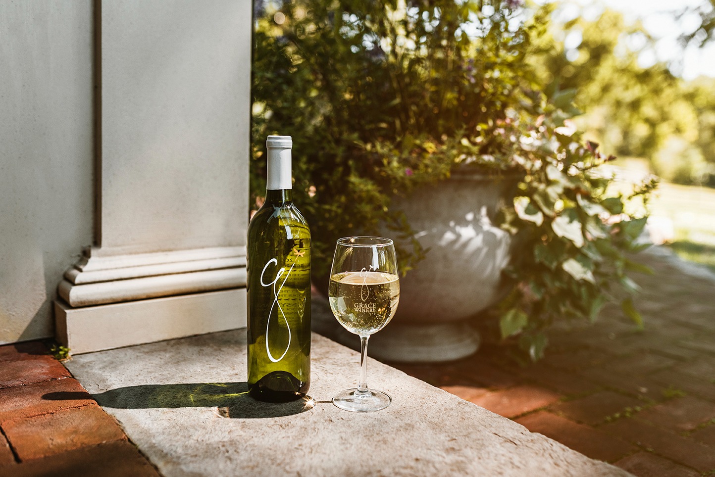 a glass of wine sitting on top of a table
