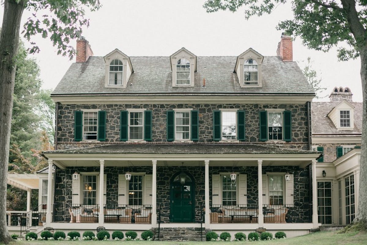 a house with trees in front of a building