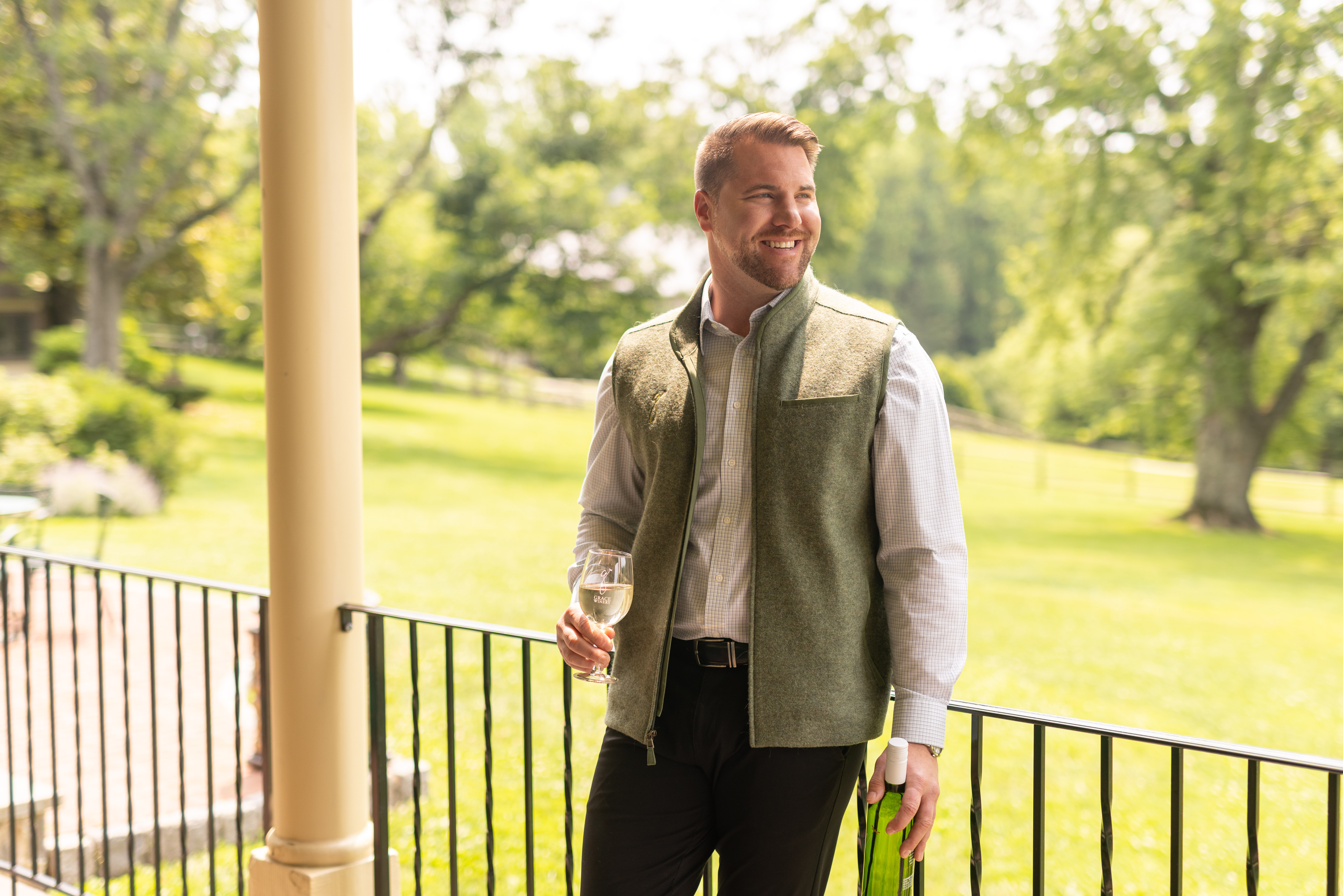 a man standing in front of a fence