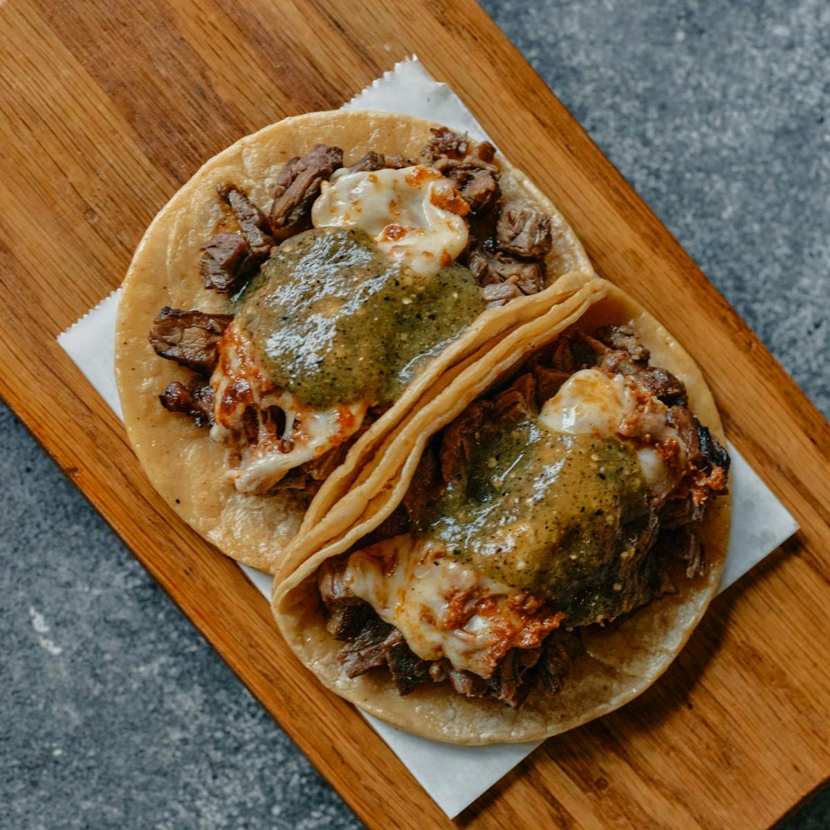 a pizza sitting on top of a wooden cutting board