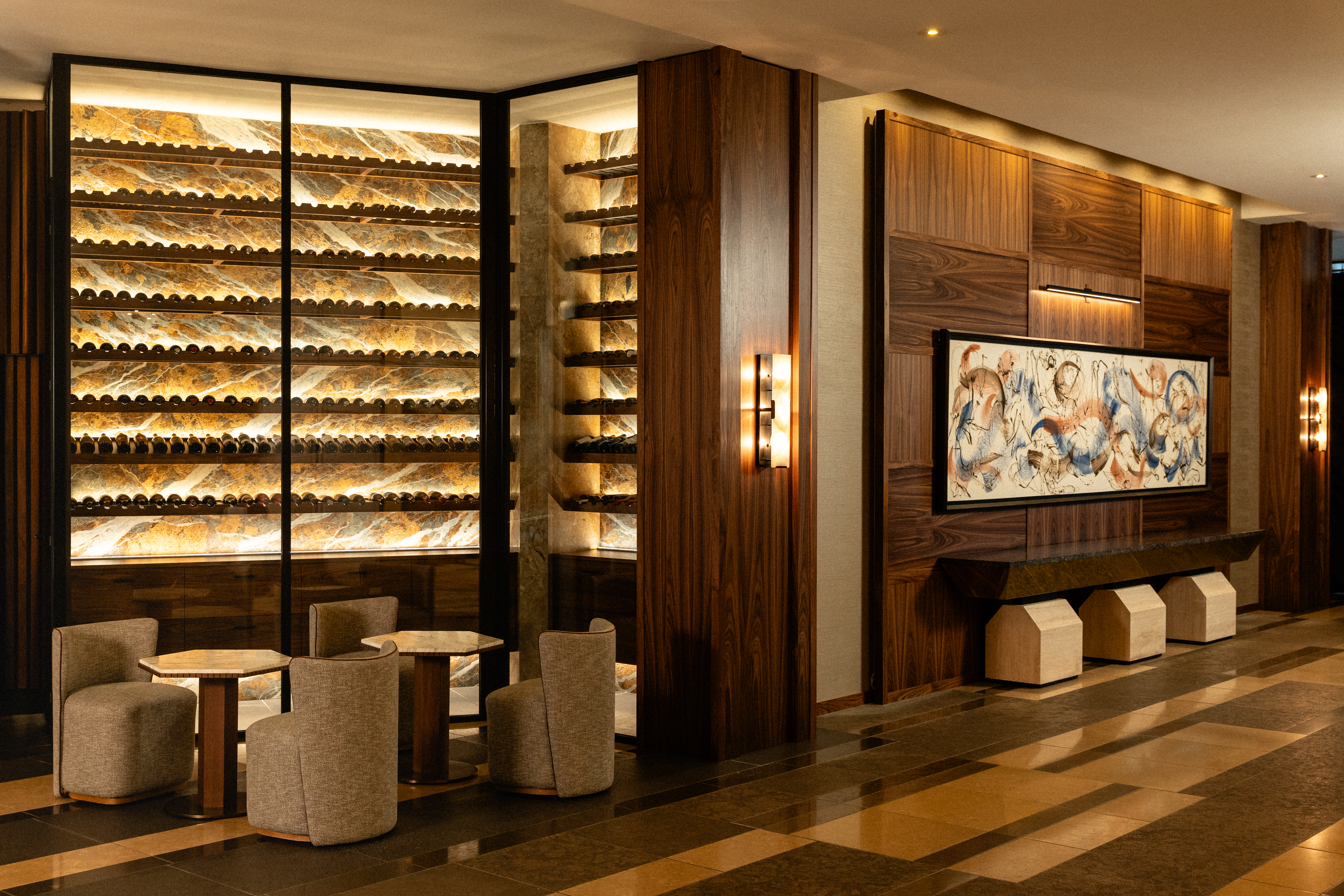 a wine cellar with a wine rack and chairs