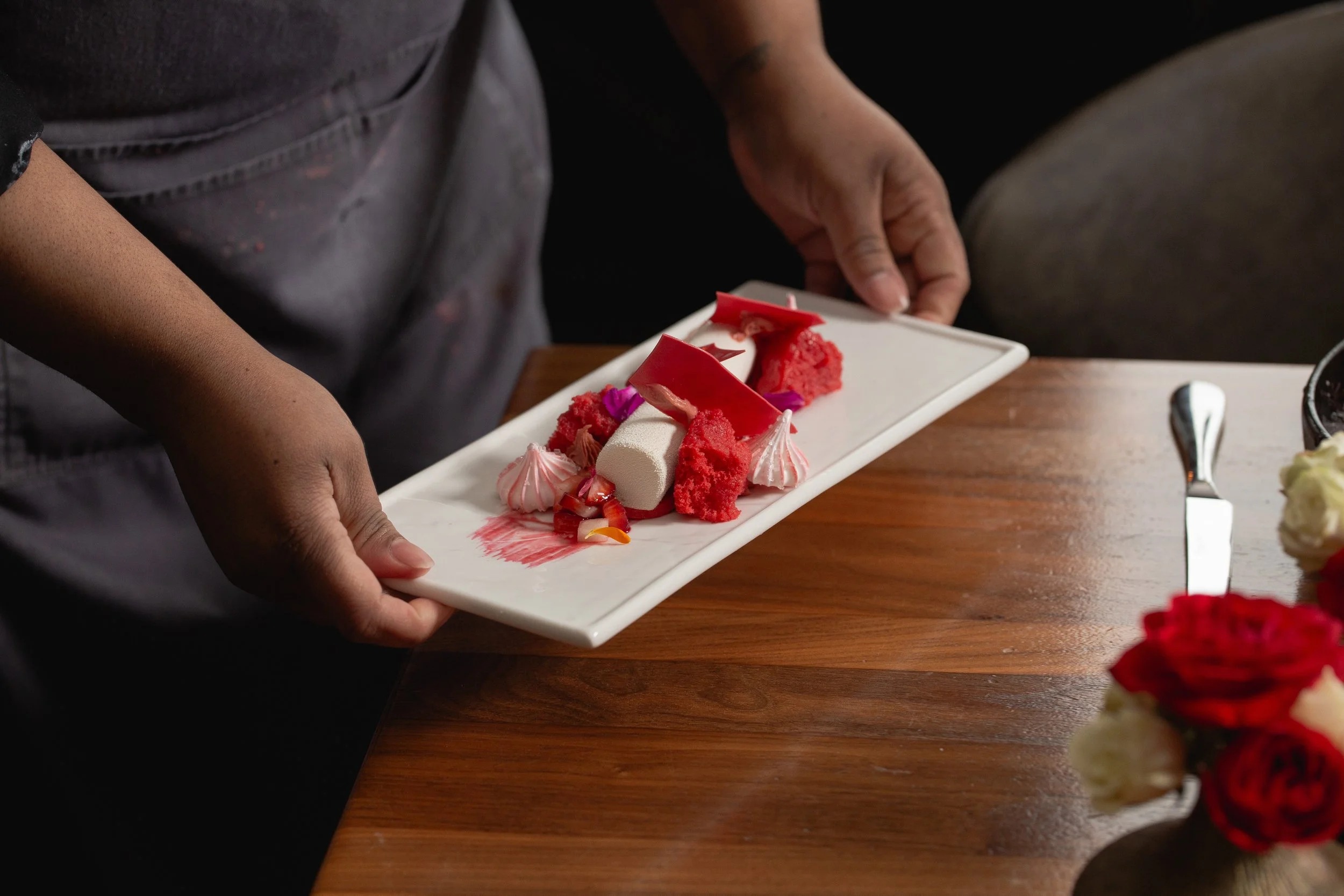 a person holding a plate of dessert