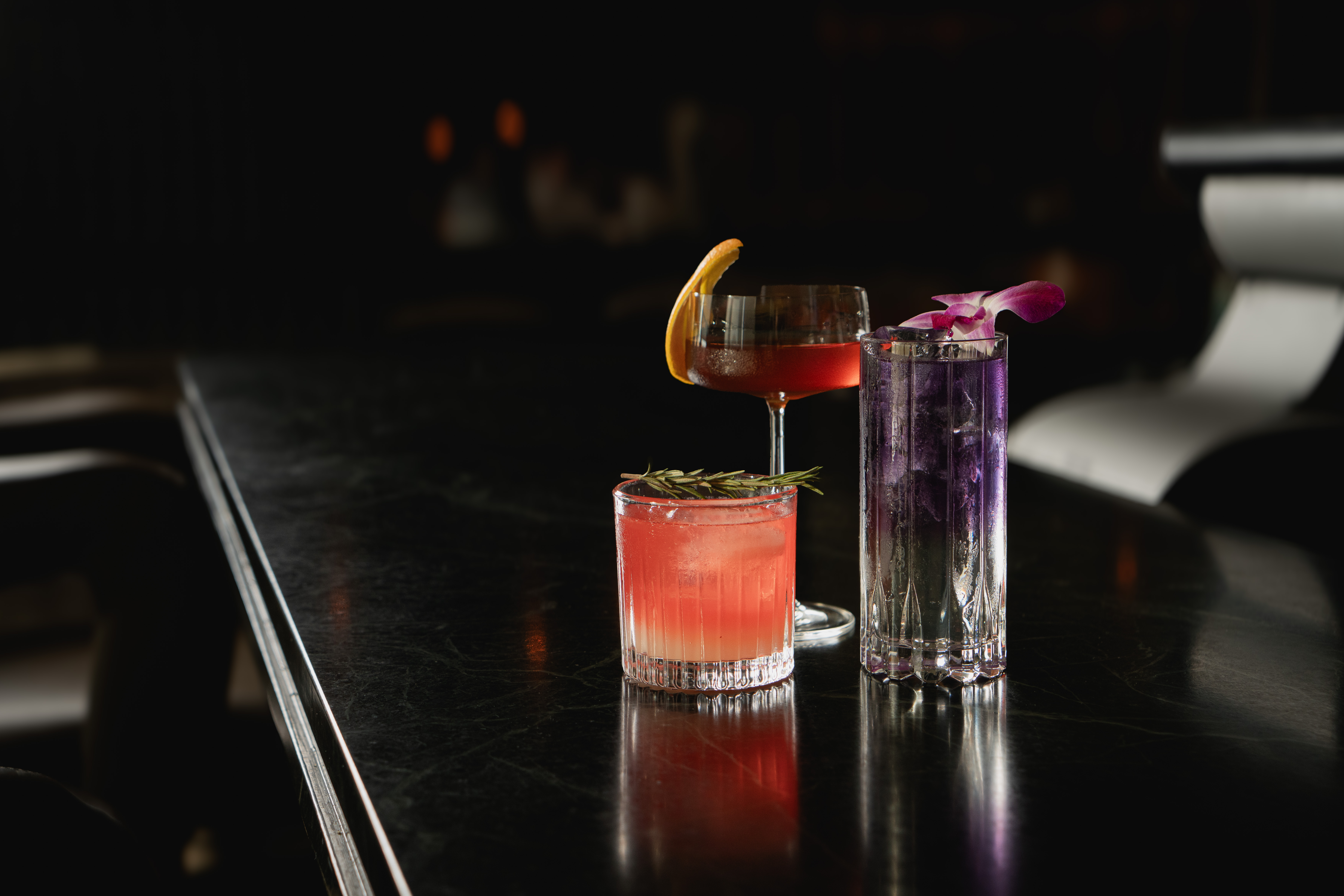 a group of drinks on a bar