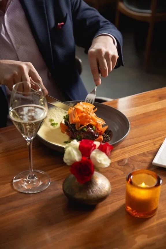 a person eating food on a table