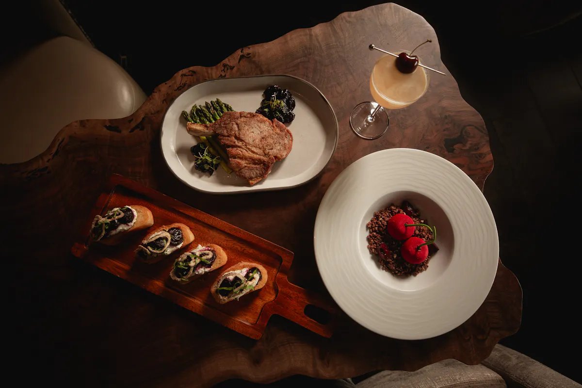 a table with plates of food and a drink