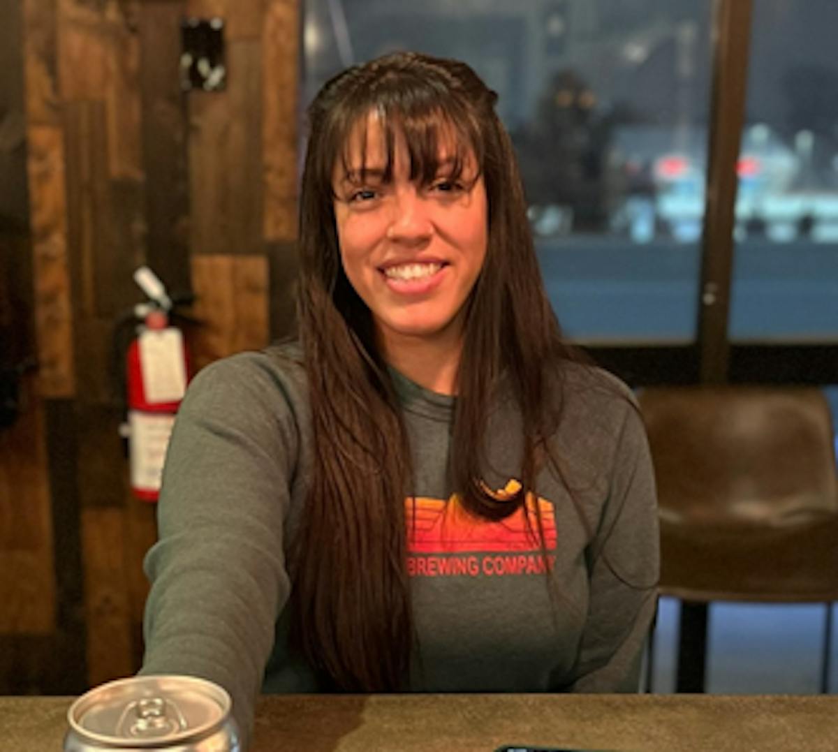a woman sitting at a table in a restaurant