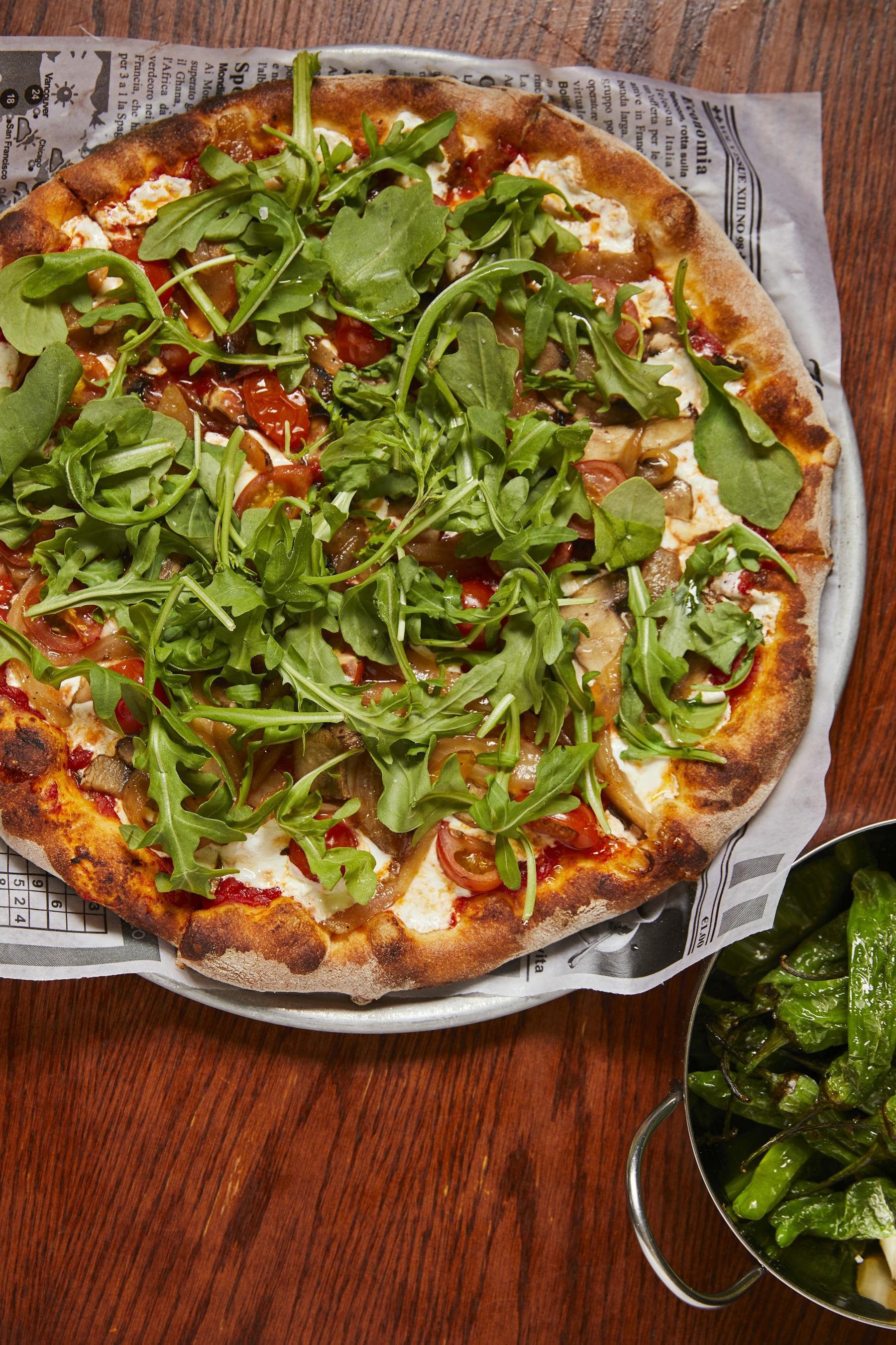 a pizza sitting on top of a wooden table