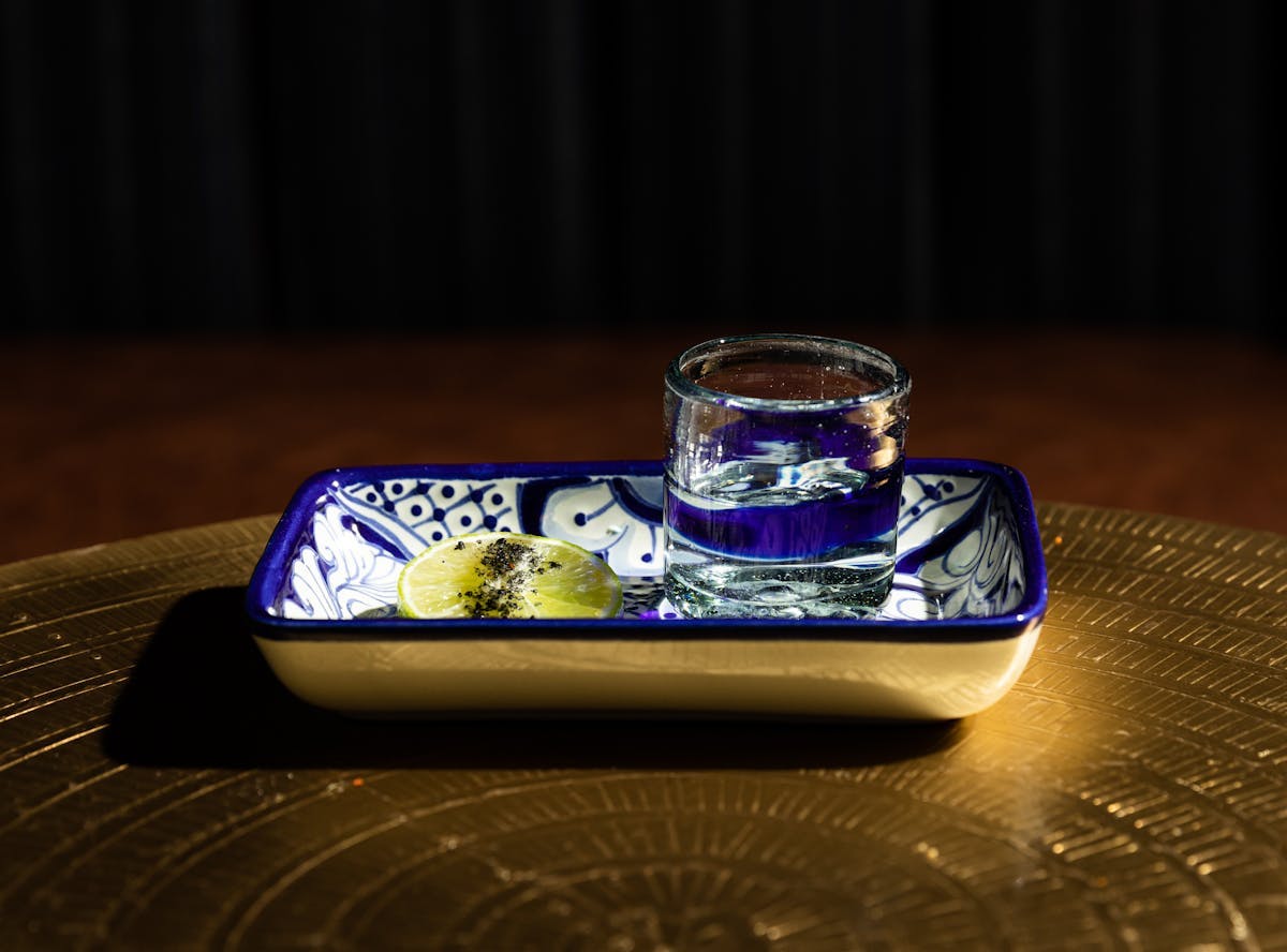 a glass with a blue bowl on a table