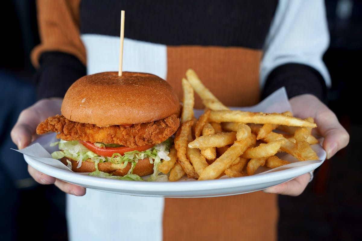 a close up of a sandwich and fries on a plate