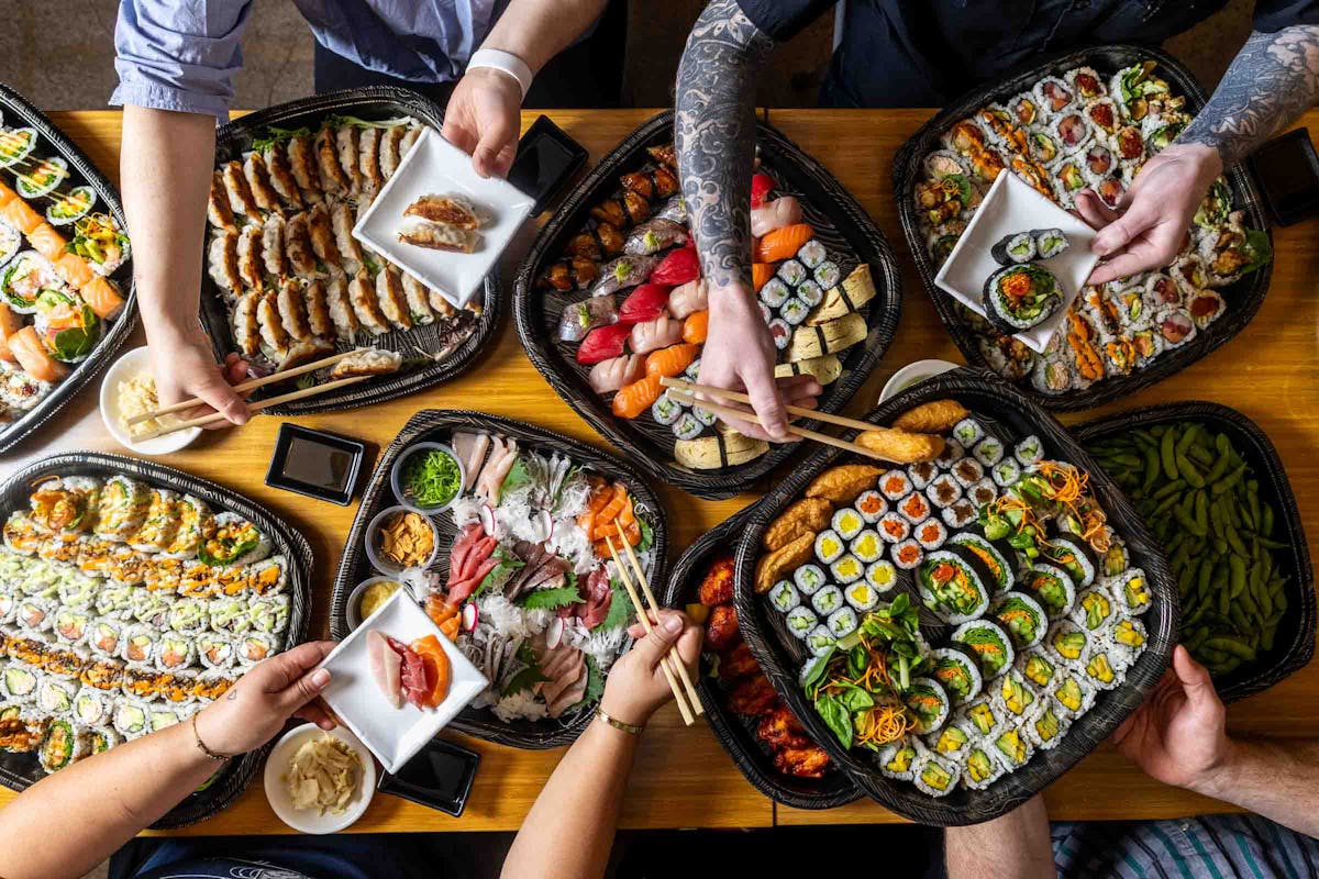 a person sitting at a table with plates of food
