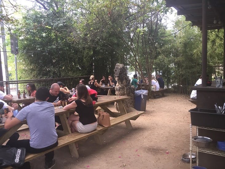 people on picnic benches outdoors