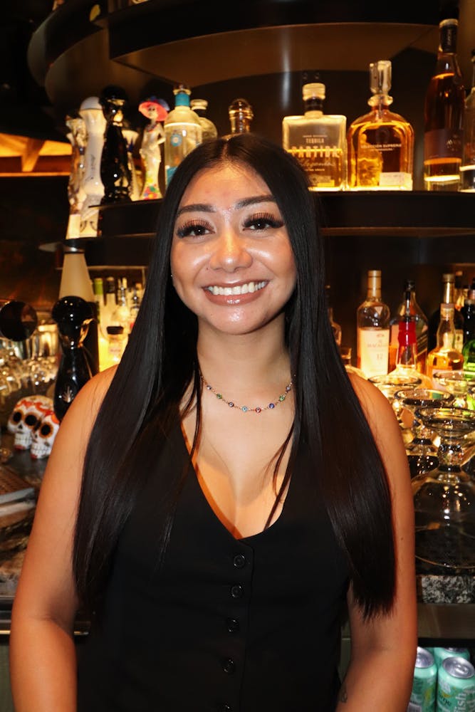 a woman wearing glasses and smiling at the camera