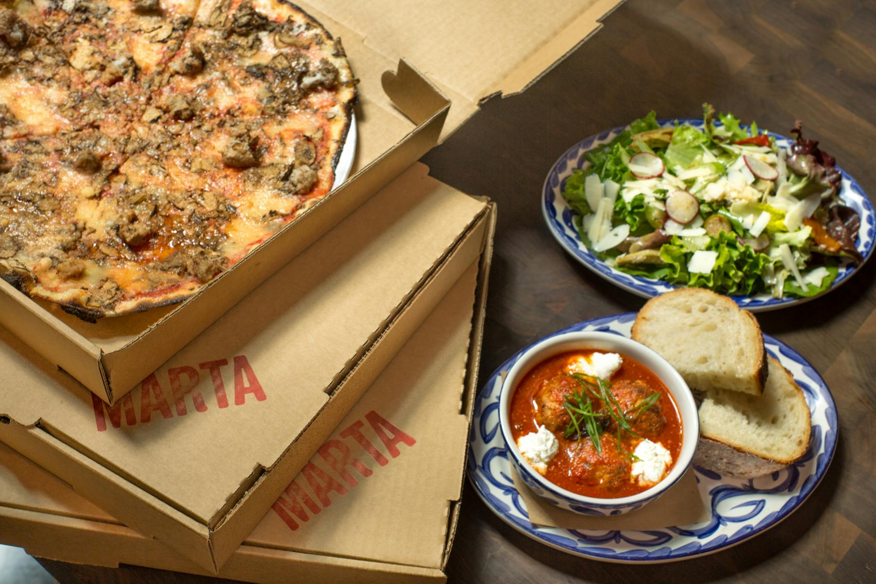 Boxes of Marta pizzas on a table