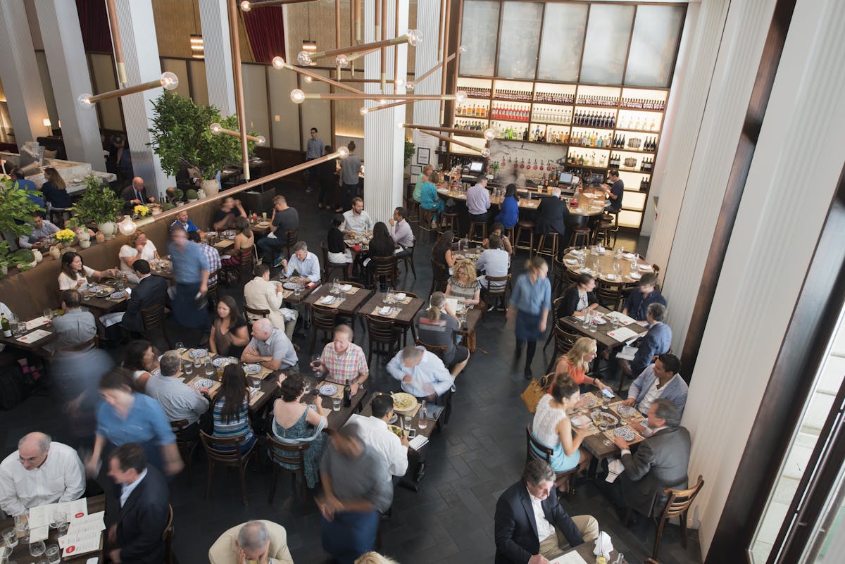 people eating in a main dining area at Marta