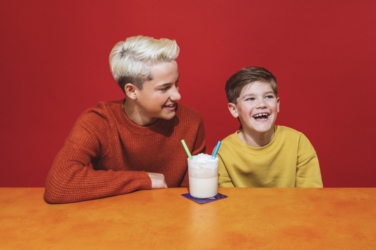 a young man sitting at a table