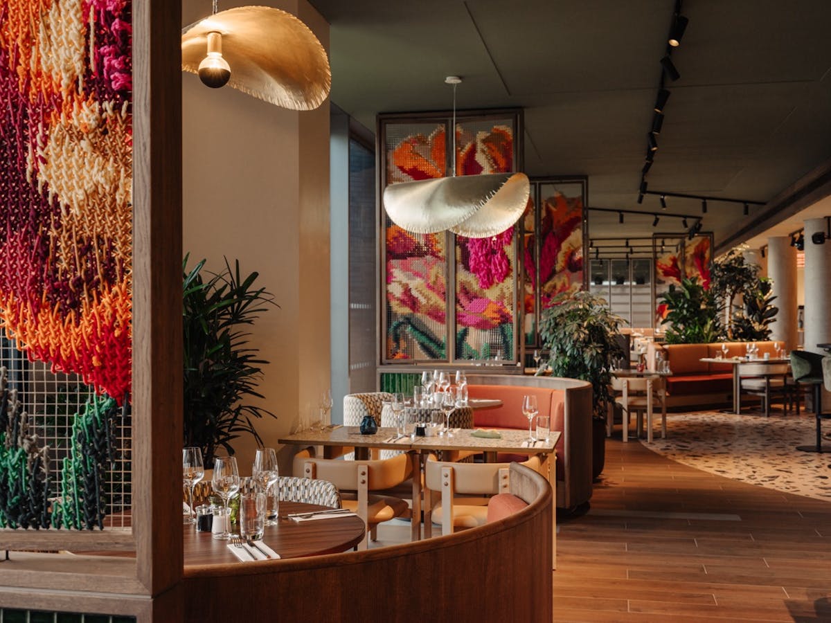 a room filled with furniture and vase of flowers on a table
